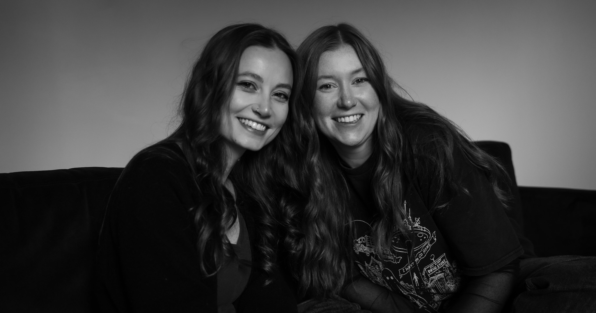 Two women sat down, smiling